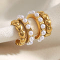 gold plated heart-link imitation pearl hoop earrings on a padded stand