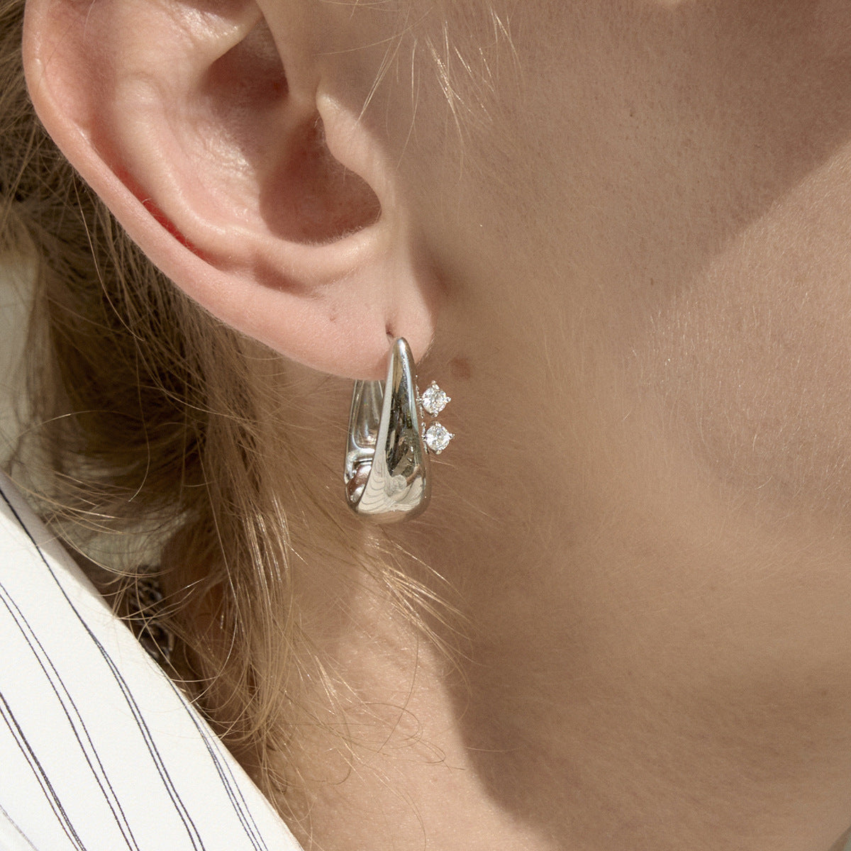 Steel color tapered hoop worn close-up