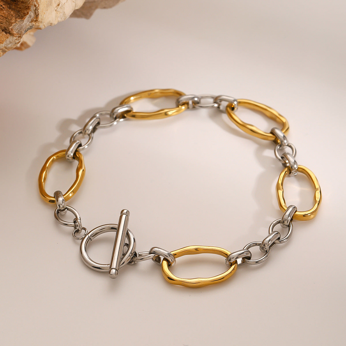 Two-tone stainless steel oval link toggle bracelet front view