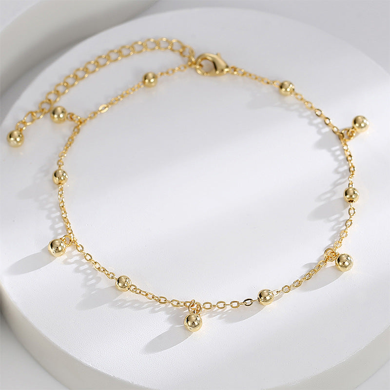 polished fixed and dangling bead anklet on white display