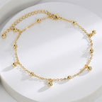 polished fixed and dangling bead anklet on white display