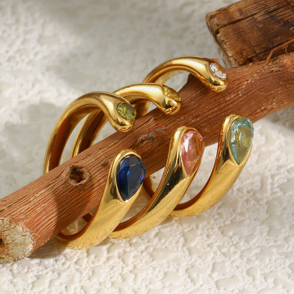 colored stone snake open rings styled on natural wood