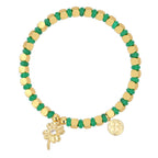 isolated gold plated clover charm bracelet with green disc beads