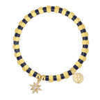 isolated dark blue cube bead bracelet with two gold plated charms