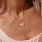 model wearing the small round pearl-style and clear-stone pendant