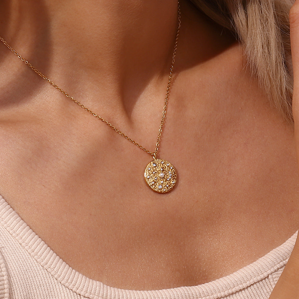 model wearing the small round pearl-style and clear-stone pendant