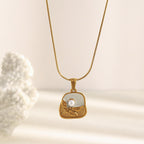 gold plated botanical plaque necklace with imitation pearl accent