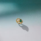 Asymmetric ring displayed on a pale surface