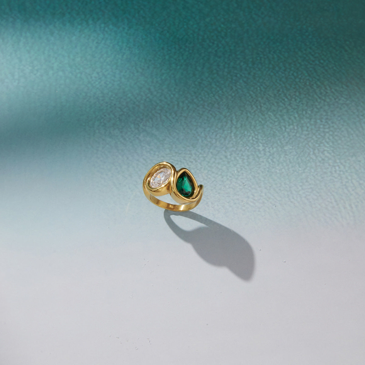 Asymmetric ring displayed on a pale surface