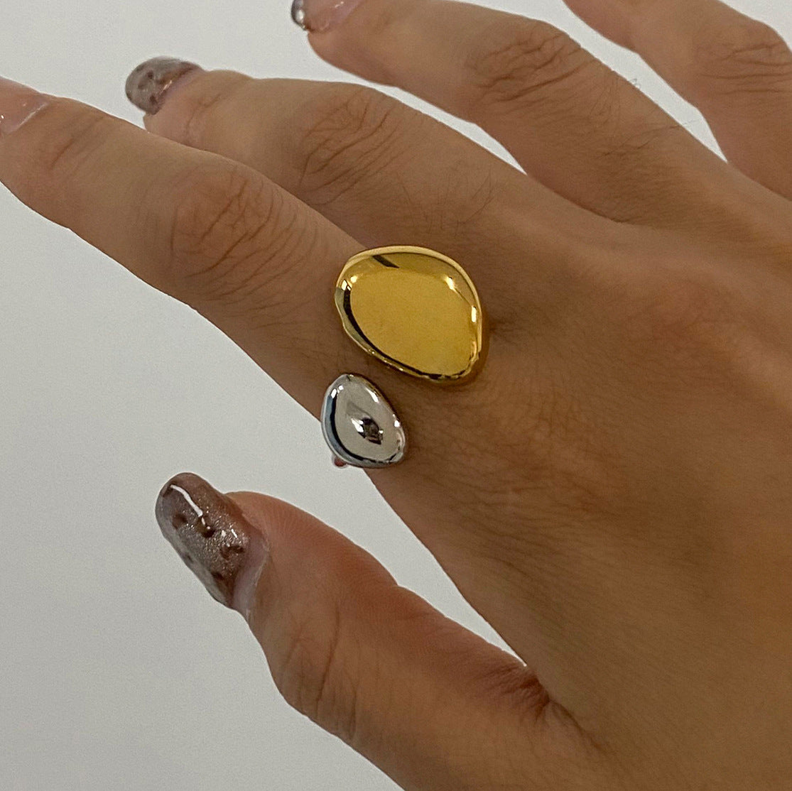 Domed oval open ring shown on a hand
