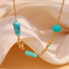 Gold plated ocean charm necklace angled view