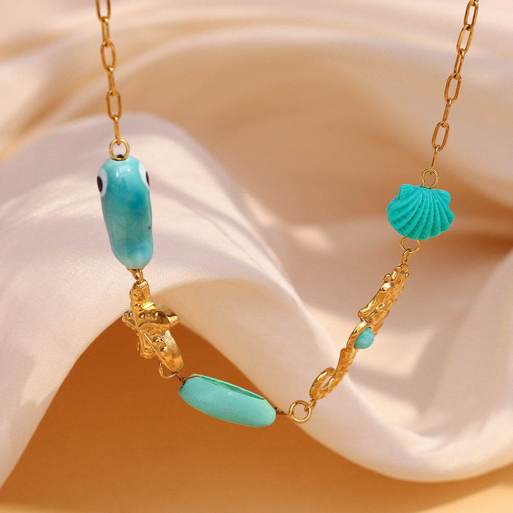Gold plated ocean charm necklace angled view