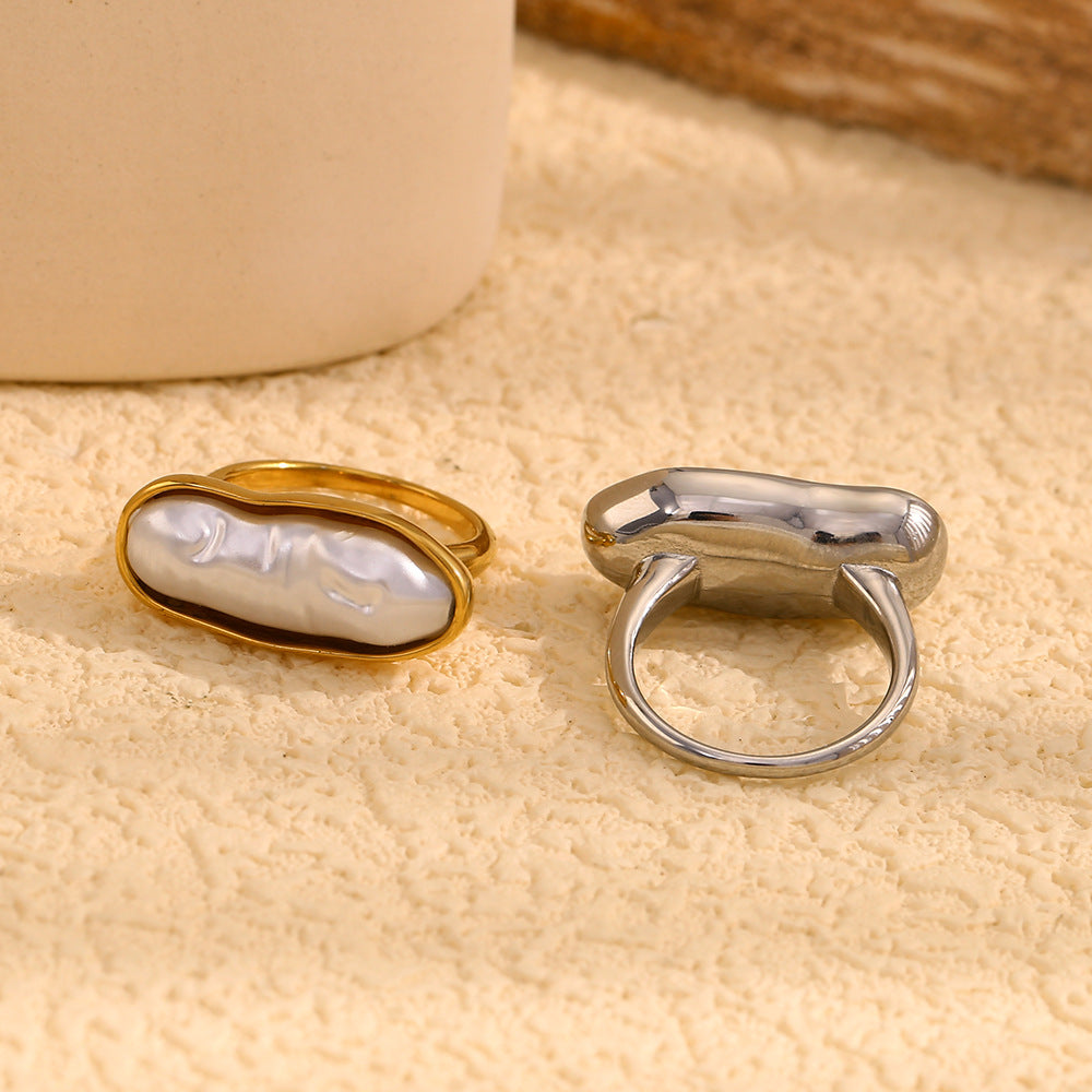 paired stainless steel elongated pearl rings shown from above and behind