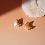 Gold Plated Stainless Steel Ivory Resin Crescent Stud Earrings — styled flat lay
