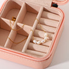 Gold plated pearl necklace arranged in a pink jewelry case