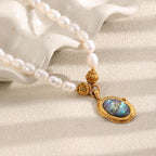white bead necklace displayed on a sculptural ceramic surface