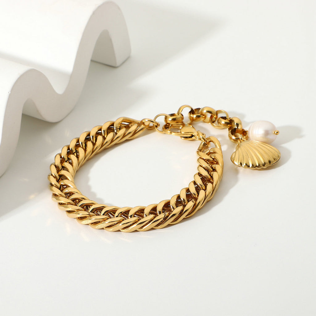 Chunky Cuban links and two charms on a white display