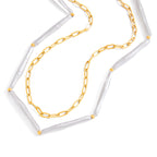 Close view of elongated white beads and paperclip chain links