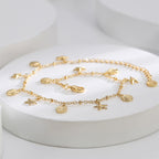 starfish and scallop charm anklet arranged on white