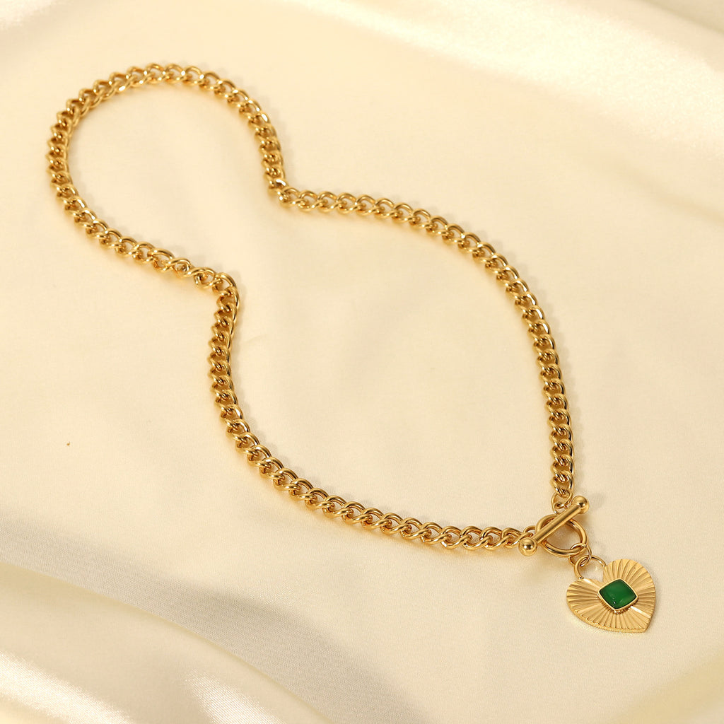 full view of the chunky gold plated heart toggle necklace on satin