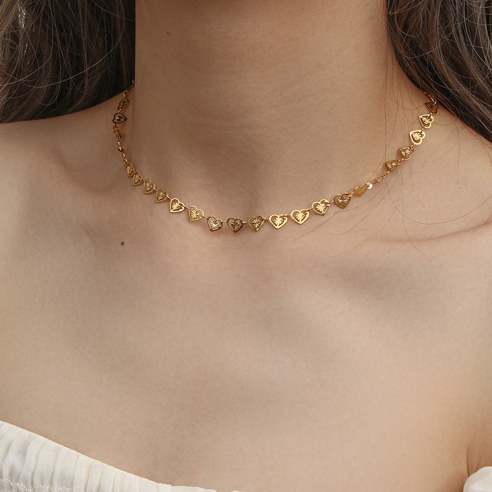 gold plated stainless steel open heart necklace worn at the collarbone