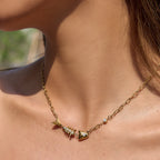 Fishbone necklace with clear accents worn at neckline