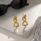 Gold-tone infinity earrings styled on display