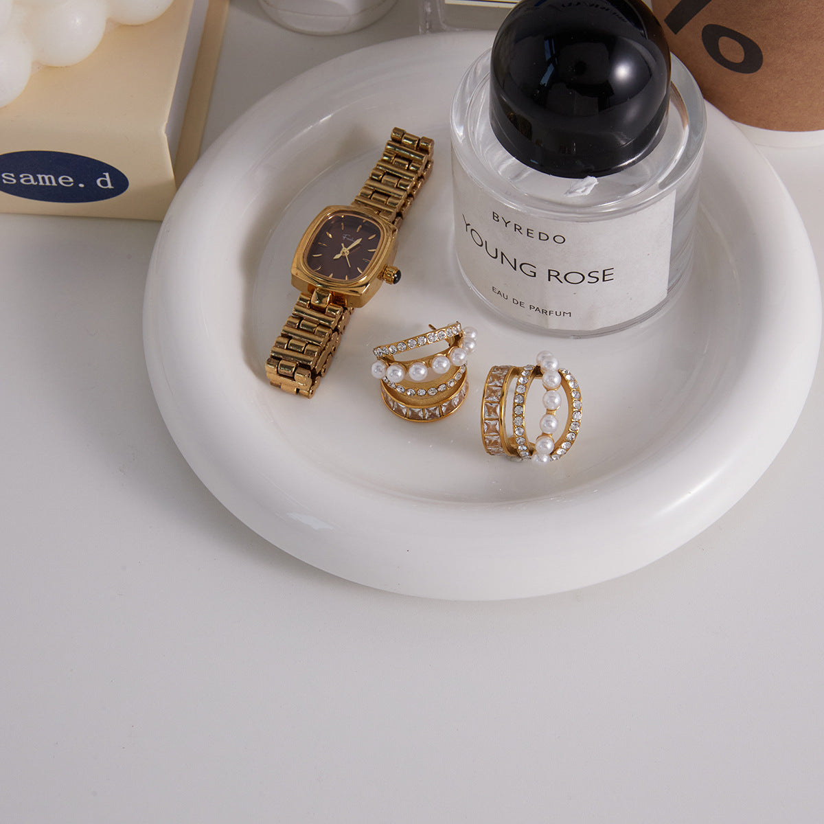 Stainless steel pearl and stone hoops arranged on a white tray