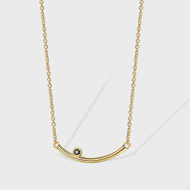gold plated brass curved bar necklace with dark accent