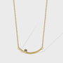 gold plated brass curved bar necklace with dark accent