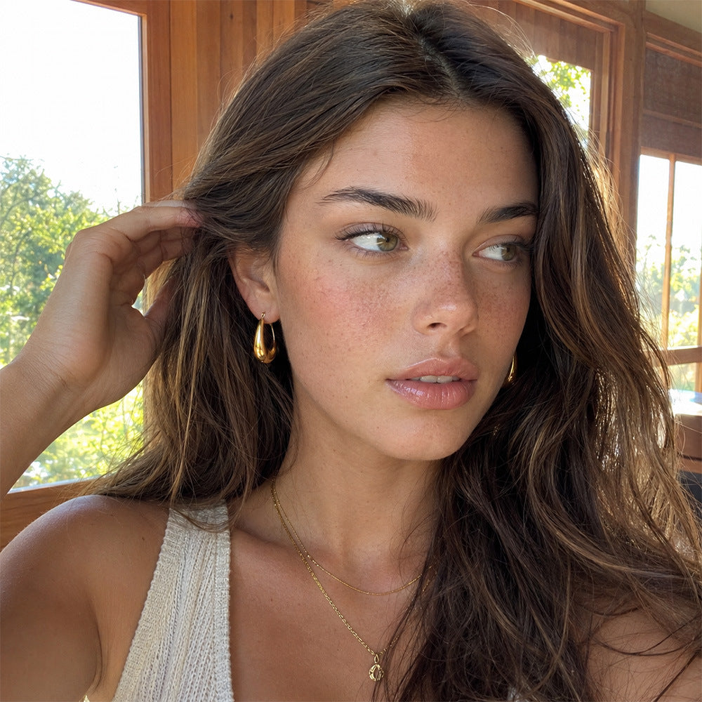 Gold plated U hoops worn by a model
