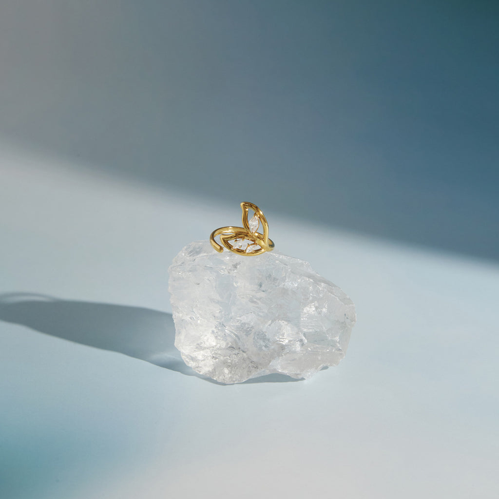 Openwork leaf ring displayed on a clear decorative stone