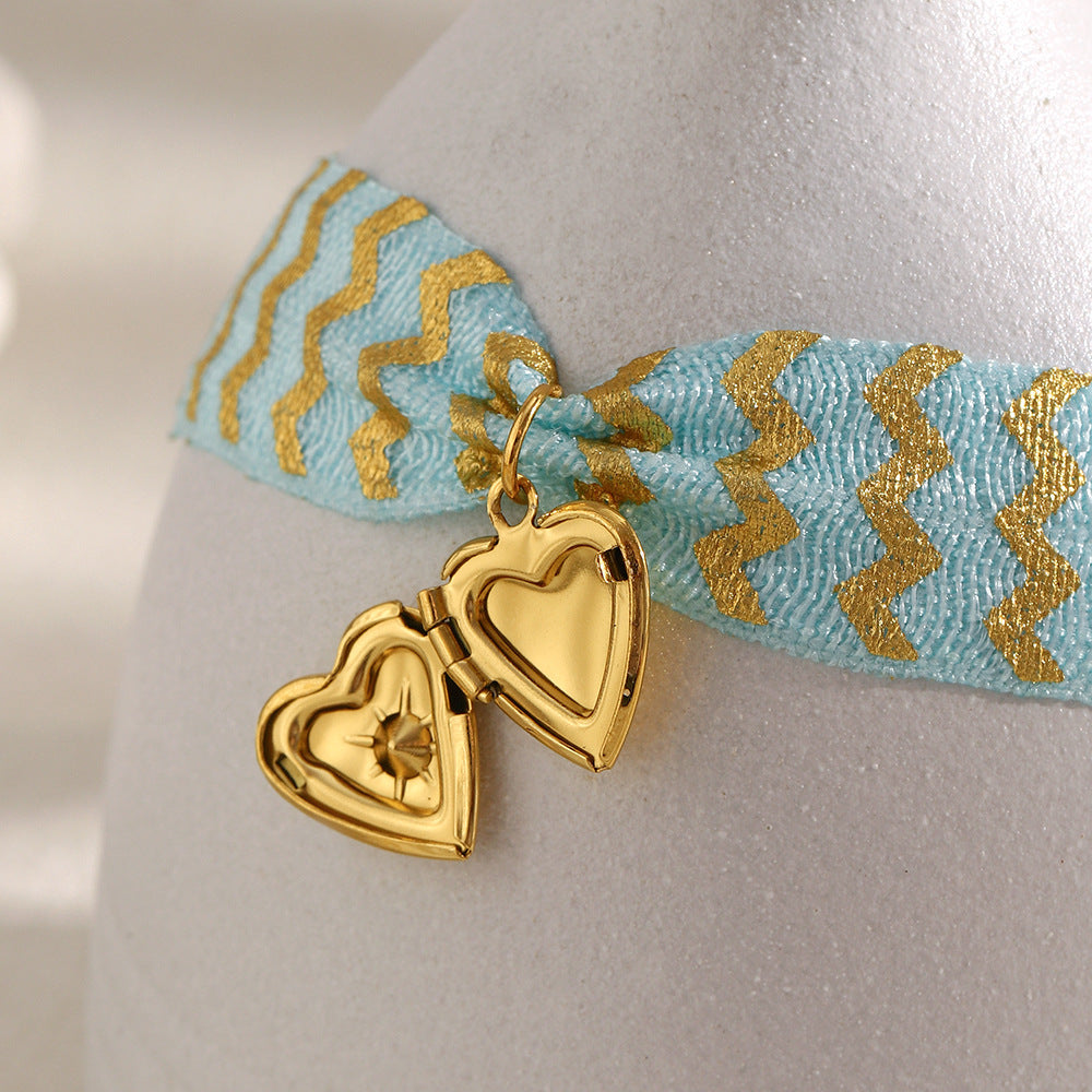Blue Fabric Tie Bracelet with Gold Plated Stainless Steel Heart Locket — open locket view