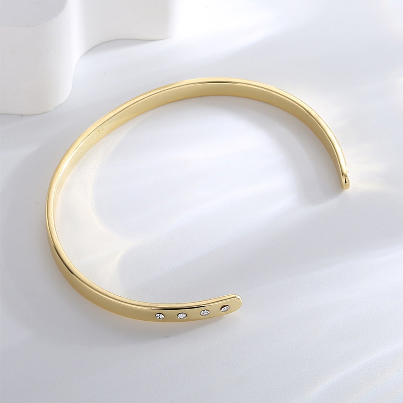 inside view of gold plated open bangle with stone-set ends