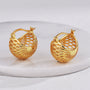 gold plated openwork sphere hoop earrings on a white display