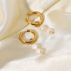 Double freshwater pearl hoops arranged on pale fabric