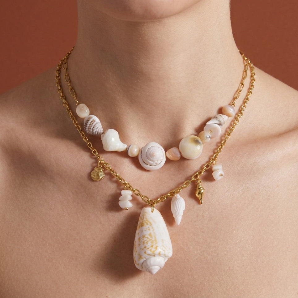 Shell pendant necklace styled with a shorter shell-bead necklace