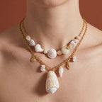 Shell pendant necklace styled with a shorter shell-bead necklace