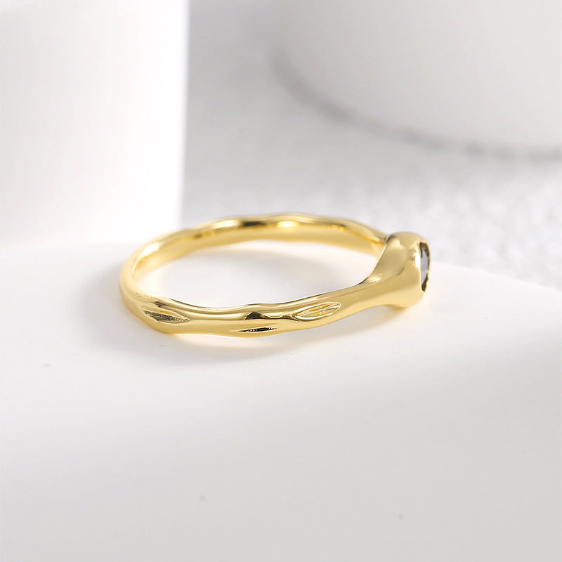 low black stone setting on the softly irregular gold plated band