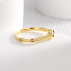 low black stone setting on the softly irregular gold plated band