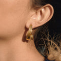 gold plated triple-strand spiral hoop earring worn from the side