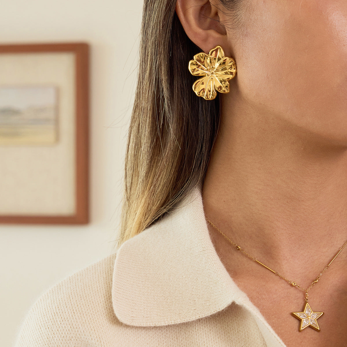 Sculpted flower stud earrings shown with a collared shirt