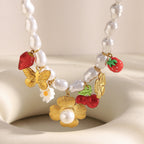 close view of fruit flower and butterfly charms on white imitation pearls
