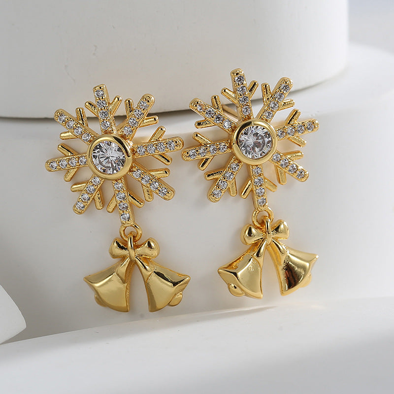 Gold plated clear-stone snowflake earrings with polished bell and bow drops