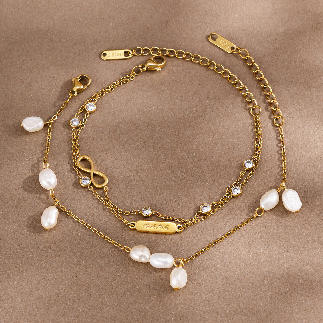 Two gold tone bracelet options showing lobster clasps and extenders