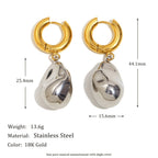 Organic silver tone drops on gold tone hoop earrings