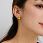 gold plated rounded dome stud earring worn on the ear
