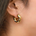 Hammered gold-tone clear-accent open hoop shown worn