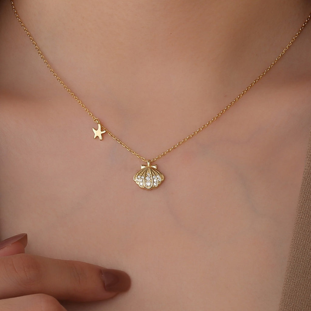 seashell and starfish necklace worn at the collarbone