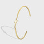 angled catalog view of gold plated lightning bolt open bangle